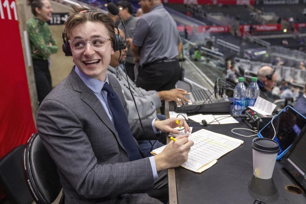 Carlo Jimenez looks back and laughs as he prepares to call a Clippers game earlier this season