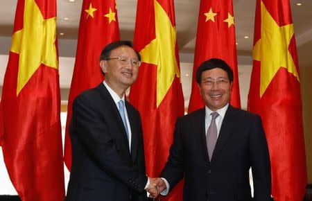 China's State Councilor Yang Jiechi (L) poses for a photo with Vietnam's Deputy Prime Minister and Foreign Minister Pham Binh Minh at the International Convention Center in Hanoi, Vietnam June 27, 2016. REUTERS/Kham