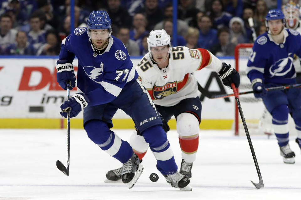 Tampa Bay Lightning defenseman Victor Hedman (77) moves the puck in front of Florida Panthers center Noel Acciari (55) during the first period of an NHL hockey game Monday, Dec. 23, 2019, in Tampa, Fla. (AP Photo/Chris O'Meara)