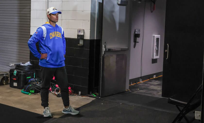 Coach Brandon Staley stands outside the locker room after his Chargers blew a 27-point playoff game lead to the Jaguars.