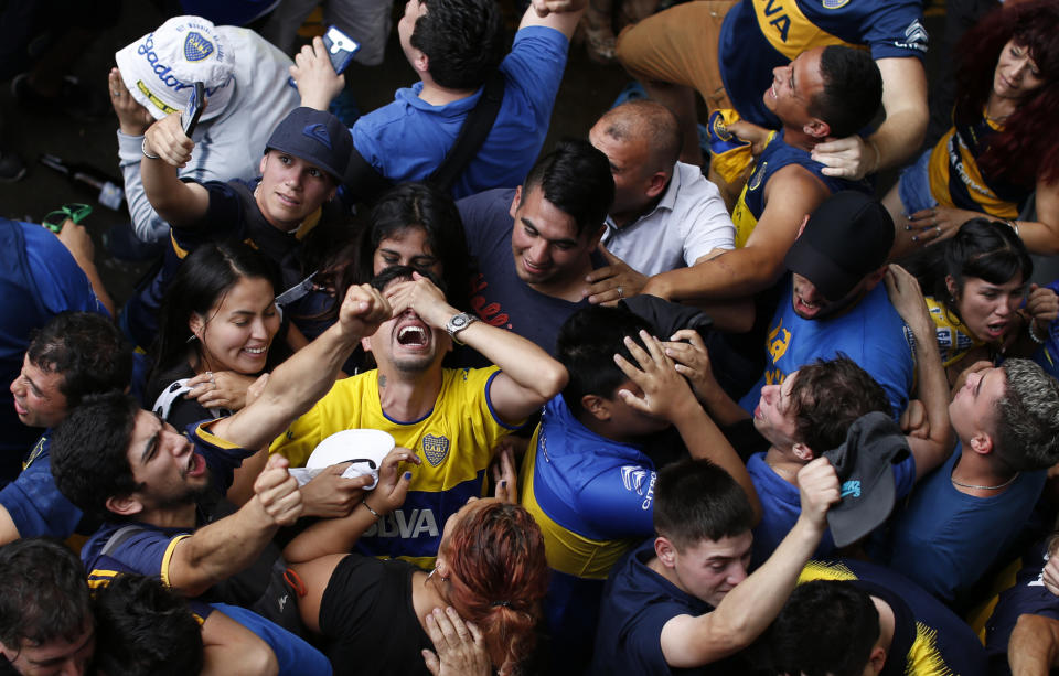 Boca Juniors soccer fans celebrate their team's goal as they watch on TV the Copa Libertadores final against River Plate in Buenos Aires, Argentina, Sunday, Dec. 9, 2018. Boca lost 3-1 the South American decider that was transferred from Buenos Aires to Madrid, Spain after River fans attacked Boca's bus on Nov. 10 ahead of the second leg. (AP Photo/Natacha Pisarenko)