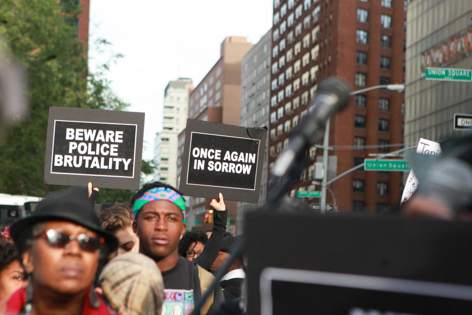 Attendees of the vigil holding signs.