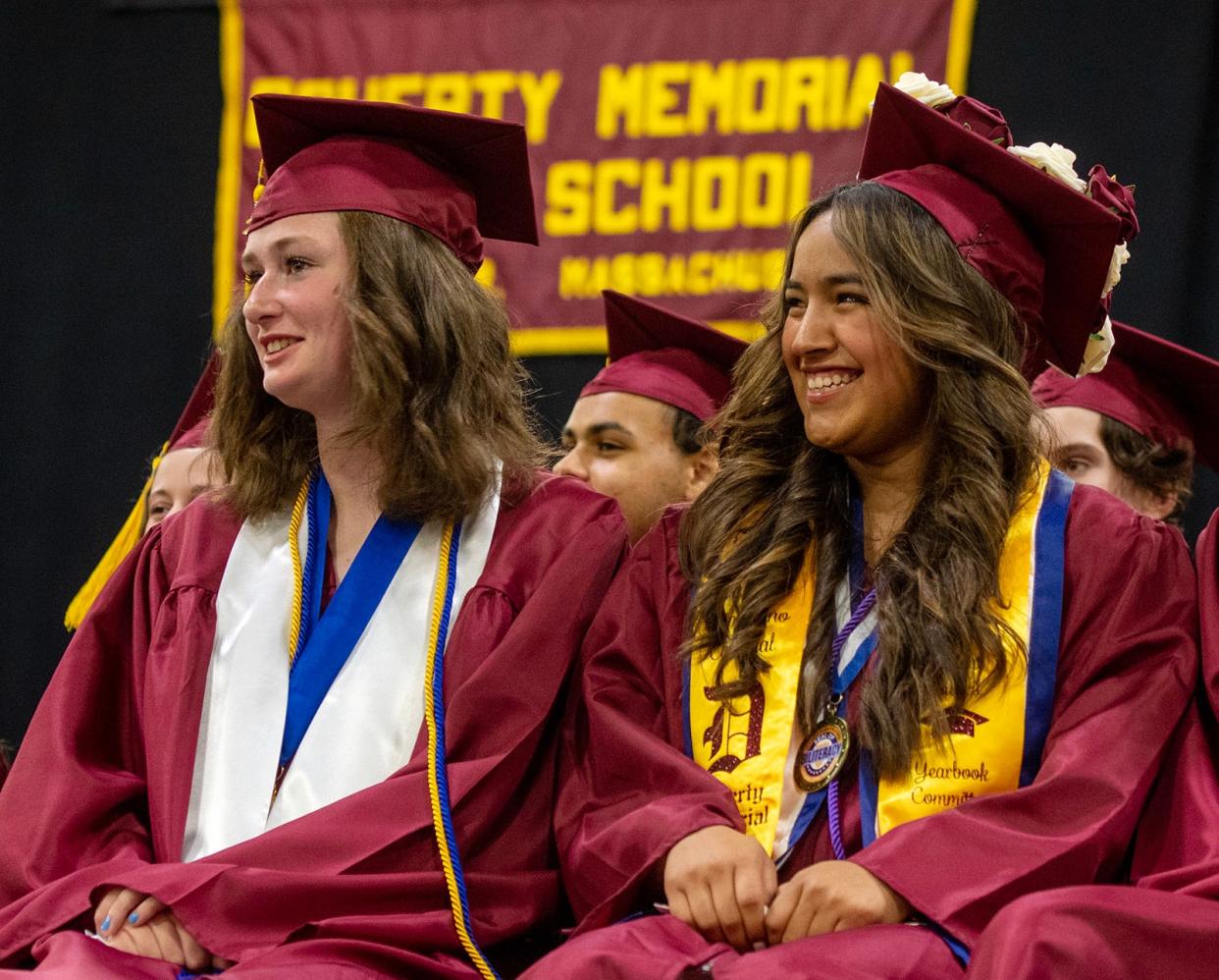 Valedictorian Nellie Ann Rushton, left, and senior class president Layla Cristina Zambrano react to a speaker during the Doherty Memorial High School commencement exercises at the DCU Center Wednesday.
