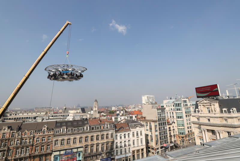 People sit at a table during "Dinner in the Sky 2.0 New Generation” in Brussels