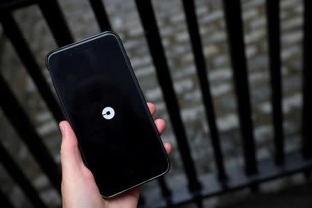 The Uber logo is seen on mobile telephone in London, Britain, September 25, 2017. REUTERS/Hannah McKay/Files