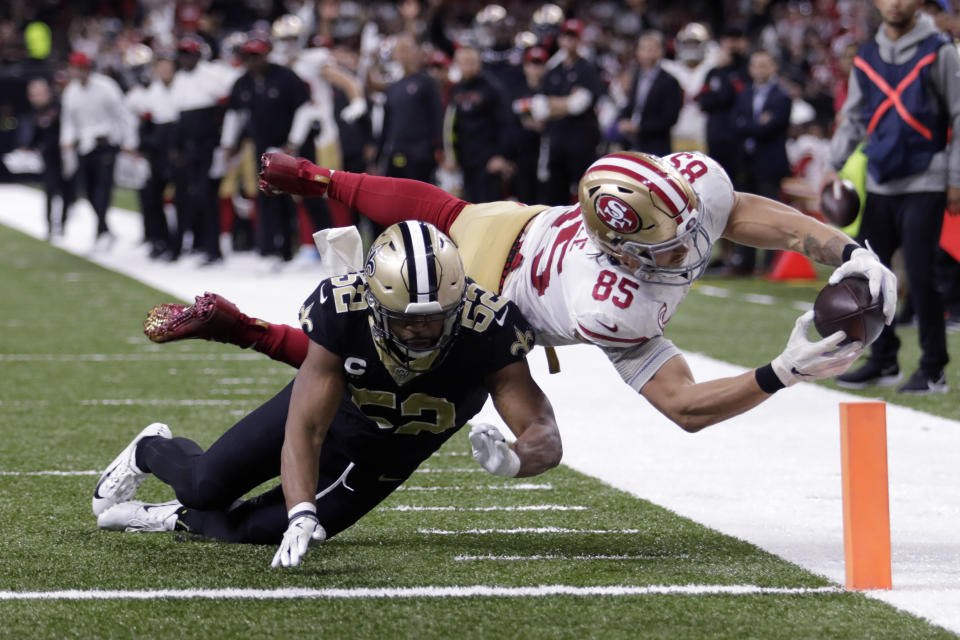 San Francisco 49ers tight end George Kittle (85) dives to the pylon for a touchdown against New Orleans Saints linebacker Craig Robertson (52) in the second half an NFL football game in New Orleans, Sunday, Dec. 8, 2019. (AP Photo/Brett Duke)
