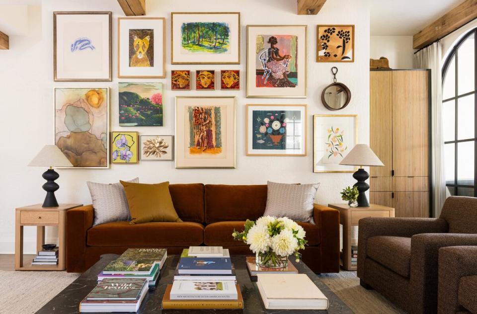 A cozy den filled with sculptural furnishings was designed to complement a gallery wall of the client’s midcentury artwork