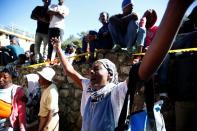 A woman reacts after a fire destroyed part of an orphanage, in Port-au-Prince