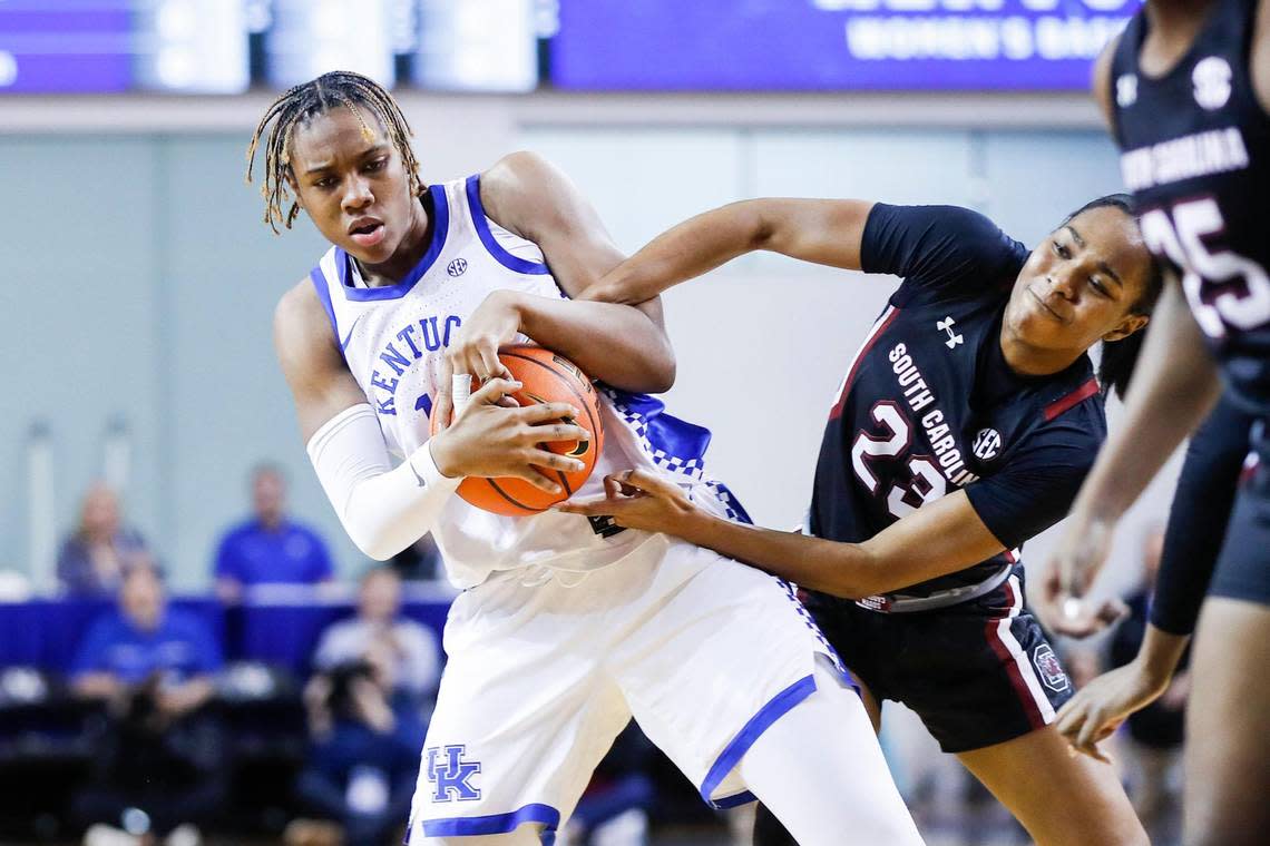 Kentucky’s Ajae Petty wrestles for the ball with South Carolina’s Bree Hall (23) during Thursday night’s game in Memorial Coliseum.