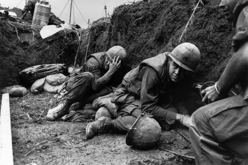 <p>US troops take cover from the Vietcong in a trench on Hill Timothy, during the Vietnam War. (Photo: Terry Fincher/Daily Express/Hulton Archive/Getty Images) </p>