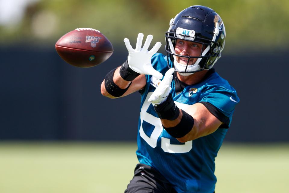 Jaguars tight end Tim Tebow participates in passing drills during minicamp.