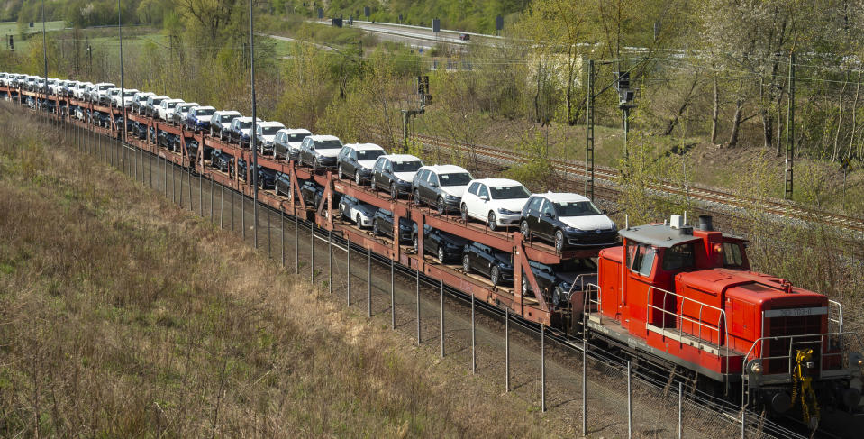 A train transports new Volkswagen cars during the production restart of the plant of the German manufacturer Volkswagen AG (VW) in Zwickau, Germany, Thursday, April 23, 2020. Volkswagen starts with step-by-step resumption of production. The car company are completely converting the plant in Zwickau from 100 percent combustion engine to 100 percent electric. (AP Photo/Jens Meyer)