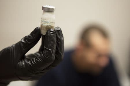 Gail Dufault, the Transitional Healthcare Coordinator at the Barnstable County House of Corrections, checks that a dose of Vivitrol is mixed properly before administering the drug to inmate Kenneth Saglibene at the prison in Buzzards Bay, Massachusetts September 2, 2014. REUTERS/Brian Snyder