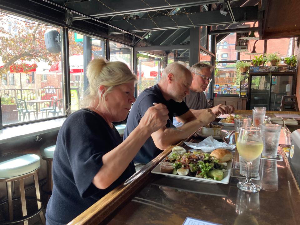 From left to right, Barbi and Mark Kresmery of Killingworth, Connecticut, and Jim Koller of Chilton, Wisconsin, enjoy lunch at the bar Sept. 14, 2023 at The Vermont Pub & Brewery in Burlington.