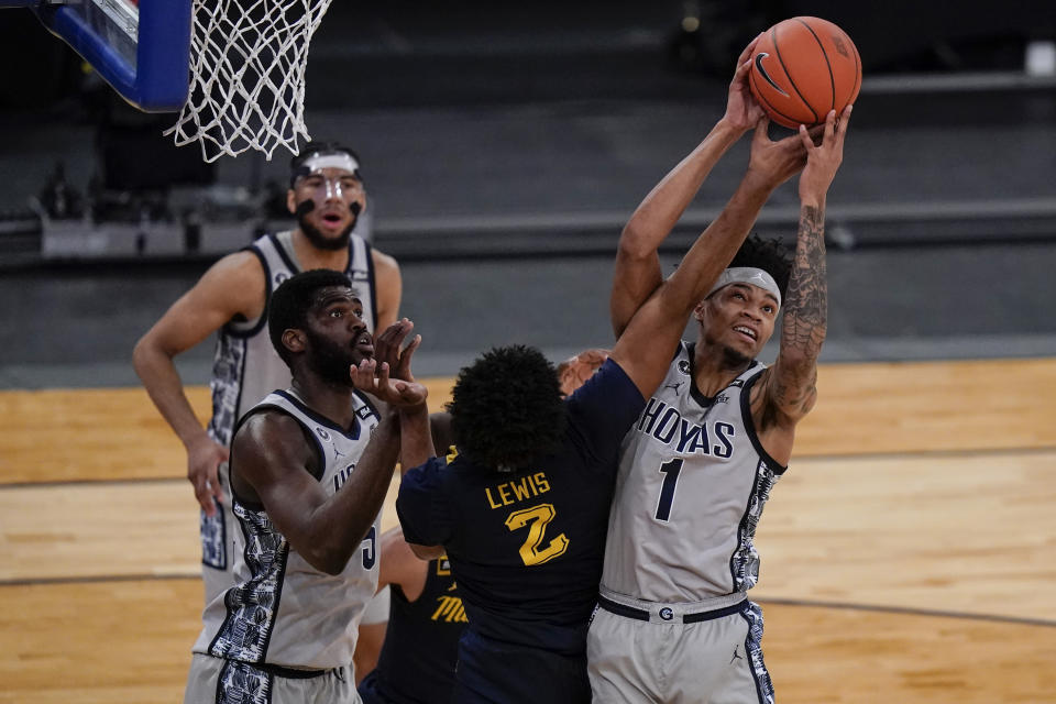 Georgetown's Jamorko Pickett (1) fights for control of the ball with Marquette's Justin Lewis (2) during the first half of an NCAA college basketball game in the Big East conference tournament Wednesday, March 10, 2021, in New York. (AP Photo/Frank Franklin II)