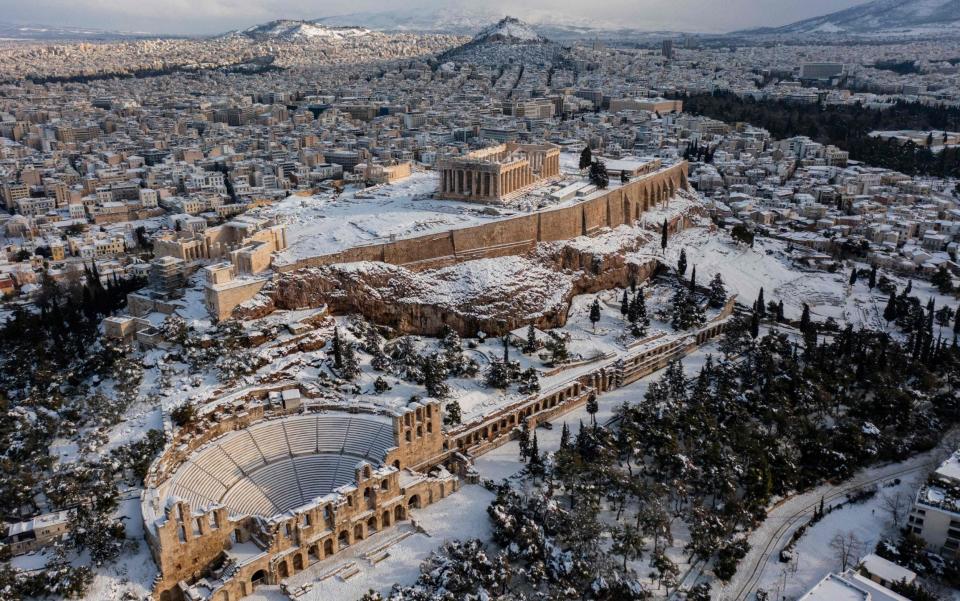 The Ancient Temple of Parthenon atop the Acropolis hill after heavy snowfall in Athens - ARIS MESSINIS /AFP