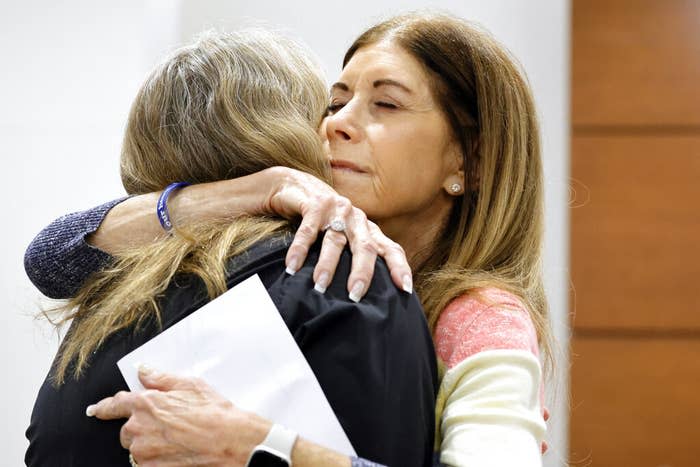 Linda Beigel Schulman (right) hugs Debra Hixon after Hixon gave a victim impact statement.