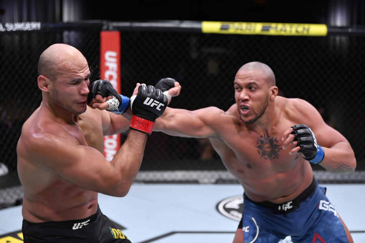 LAS VEGAS, NEVADA - DECEMBER 12:  (R-L) Ciryl Gane of France punches Junior Dos Santos of Brazil in their heavyweight bout during the UFC 256 event at UFC APEX on December 12, 2020 in Las Vegas, Nevada. (Photo by Jeff Bottari/Zuffa LLC)