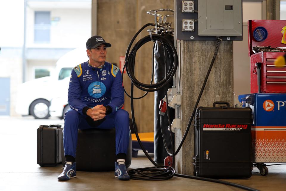 Jimmie Johnson sits and waits during one of several rain delays during his rookie orientation program at IMS on Wednesday.