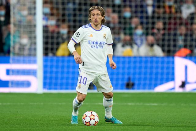 Real Madrid's Luka Modric, right, heads the ball past Manchester