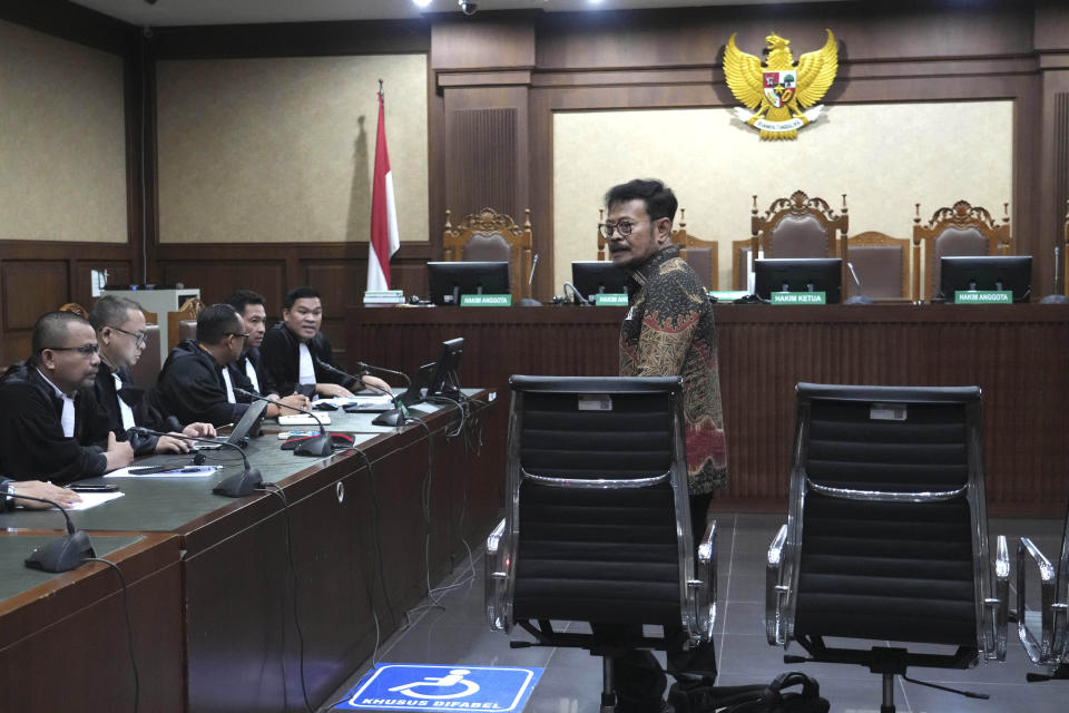 Former Indonesian Agriculture Minister Syahrul Yasin Limpo, center, takes his seat on the defendant's chair upon arrival for his sentencing hearing on a corruption case at the Corruption Court in Jakarta, Indonesia Thursday, July 11, 2024. Indonesia’s anti-graft court sentenced the former agriculture minister to 10 years in prison Thursday after finding him guilty of corruption-related extortion, abuse of power and bribery involving ministry contracts with private vendors. (AP Photo/Tatan Syuflana)