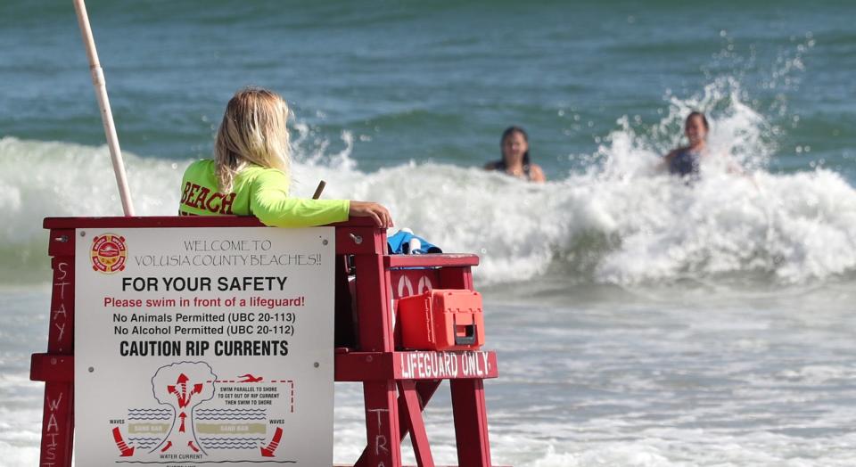 A Volusia County Beach Safety Ocean Rescue lifeguard keeps watch on swimmers on Sept. 28, 2021.