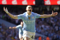 Manchester City's Phil Foden celebrates after scoring his side's opening goal during the English Premier League soccer match between Manchester City and West Ham United at the Etihad Stadium in Manchester, England, Sunday, May 19, 2024. (AP Photo/Dave Thompson)