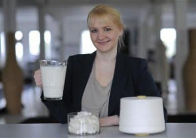 Designer Anke Domaske poses with milk, milk fiber, and milk yarn. Photo courtesy of Reuters/Fabian Bimmer