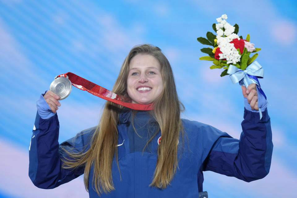 Julia Marino of the U.S. shows her silver medal for the snowboard event during the awards ceremony at the 2022 Winter Olympics, Sunday, Feb. 6, 2022, in Zhangjiakou, China. (AP Photo/Kirsty Wigglesworth)