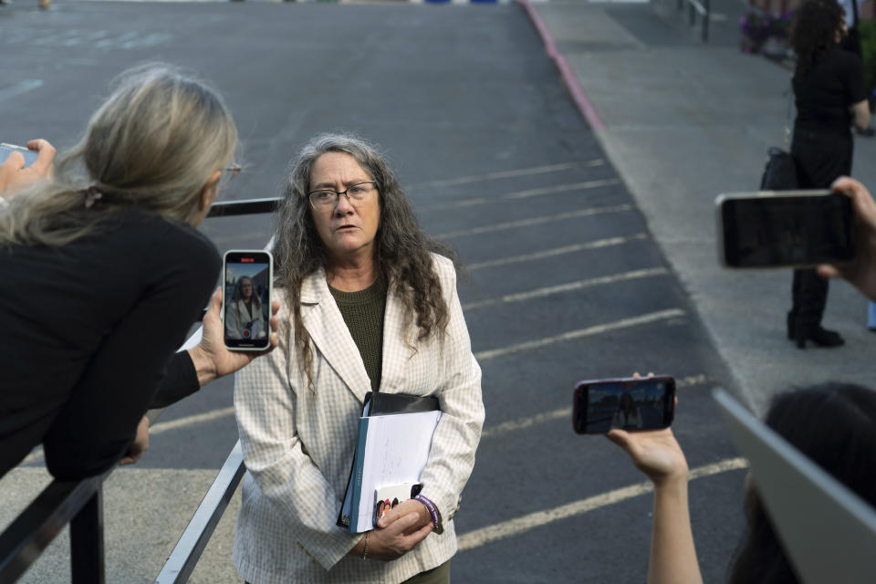 Wendy Olson, center, an attorney representing a coalition of news organizations including The Associated Press, talks to reporters after a hearing in Latah County District Court, Wednesday, Sept. 13, 2023, in Moscow, Idaho, after Olson asked Second District Judge John C. Judge to continue to allow cameras in the courtroom in the trial of Bryan Kohberger, who is accused of killing four University of Idaho students in November 2022. (AP Photo/Ted S. Warren)