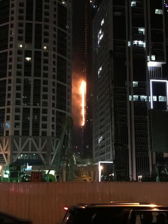 Flames shoot up the side of the Torch tower residential building in the Marina district, Dubai, United Arab Emirates, August 4, 2017. REUTERS/Abed Al Hadi Al Ramahi