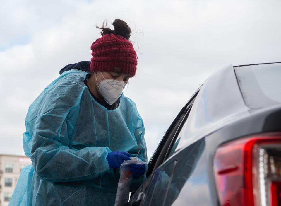 Physician assistant Abbey McMurrary prepares to swap a patient's nose for a Covid test at a COVID-19 testing and Vaccination site on 28th and Charlotte in Nashville, Tenn., Monday, Jan. 3, 2022.