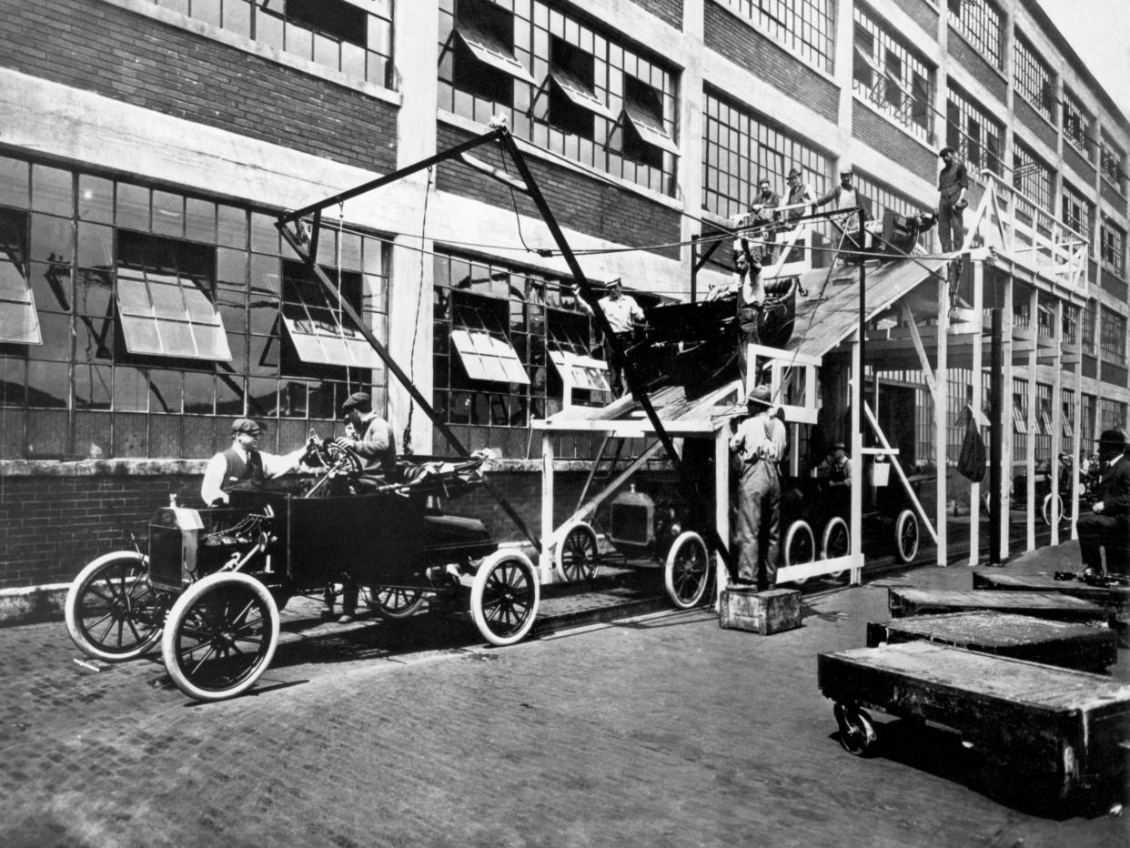 View of a portion of the assembly line for Model T automobiles at a Ford manufacturing plant (probably the one in Highland Park, Michigan), 1913.