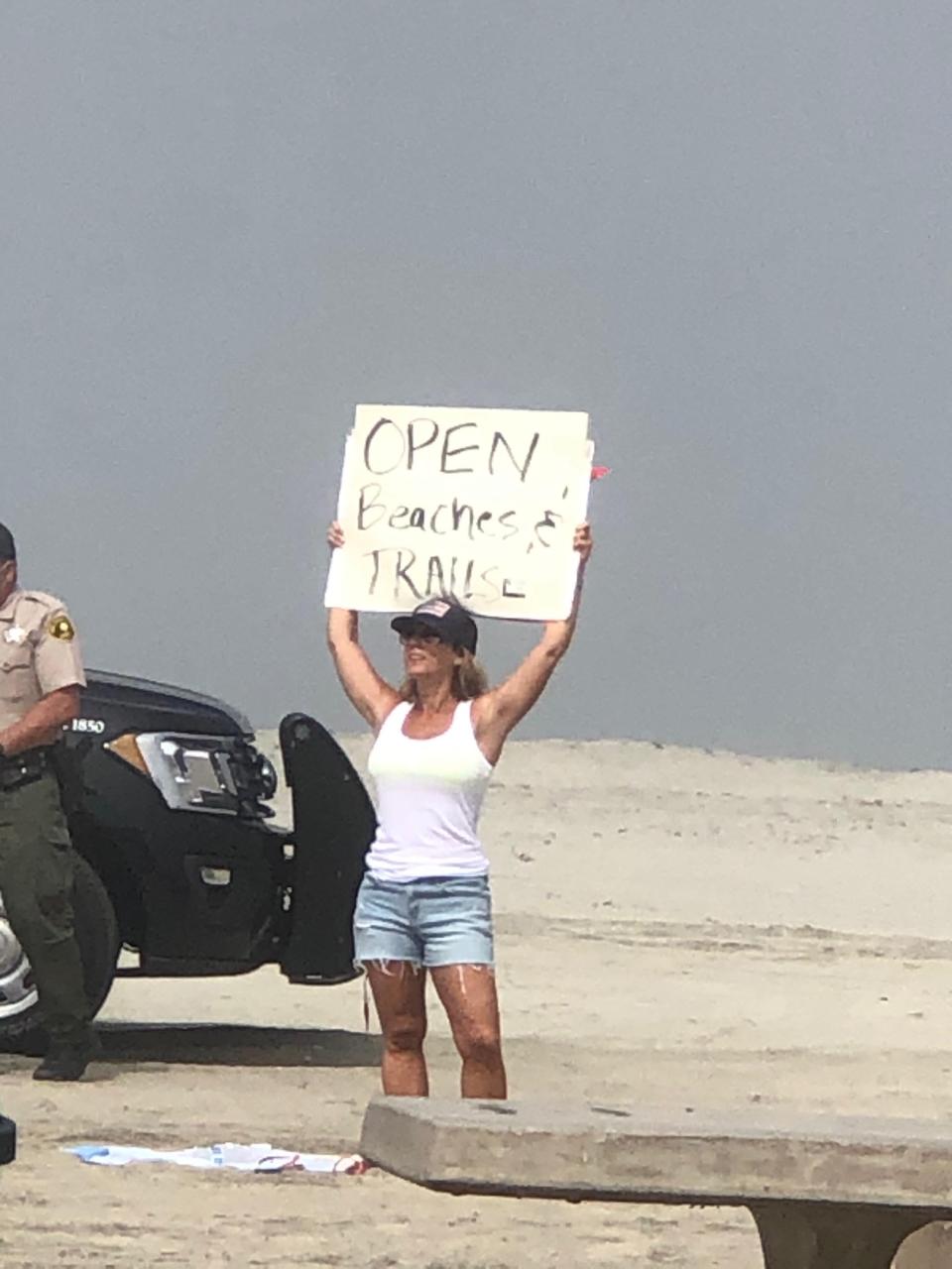 Crista Anne Curtis protests at Moonlight Beach in Encinitas, California, on Saturday, April 25.