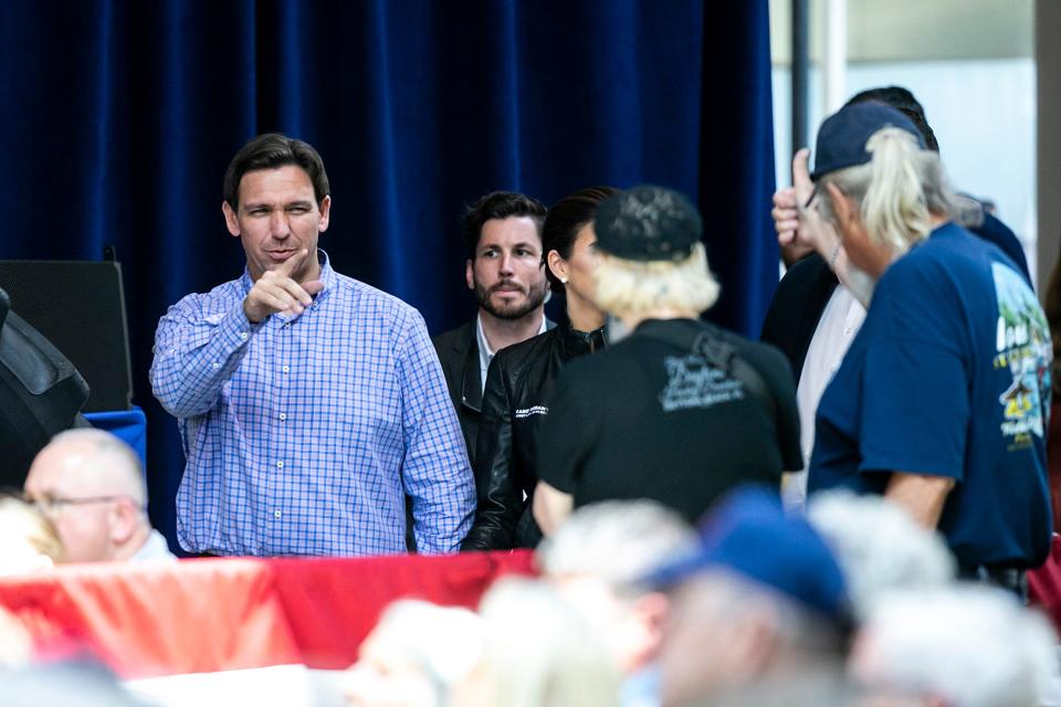 Republican presidential candidate Florida Gov. Ron DeSantis points to a supporter in the crowd during the annual Roast and Ride fundraiser for U.S. Sen. Joni Ernst, Saturday, June 3, 2023, at the Iowa State Fairgrounds in Des Moines, Iowa.