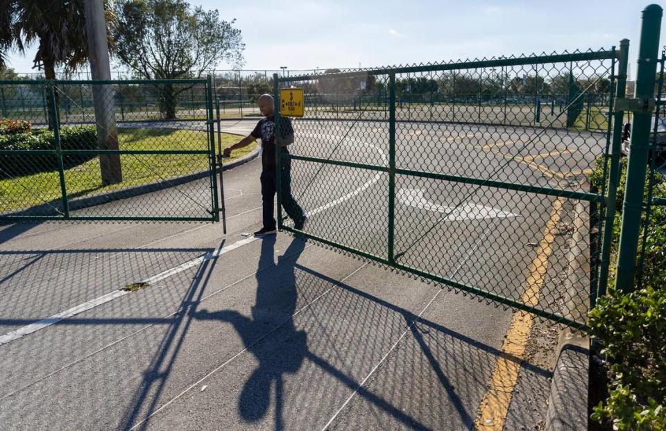 A school personnel closes the main entrance to Pines Middle School after students were picked up by their guardians on Wednesday, Jan. 31, 2024, in Pembroke Pines, Fla. Pines Middle is one of various Broward County Schools with low student enrollment.