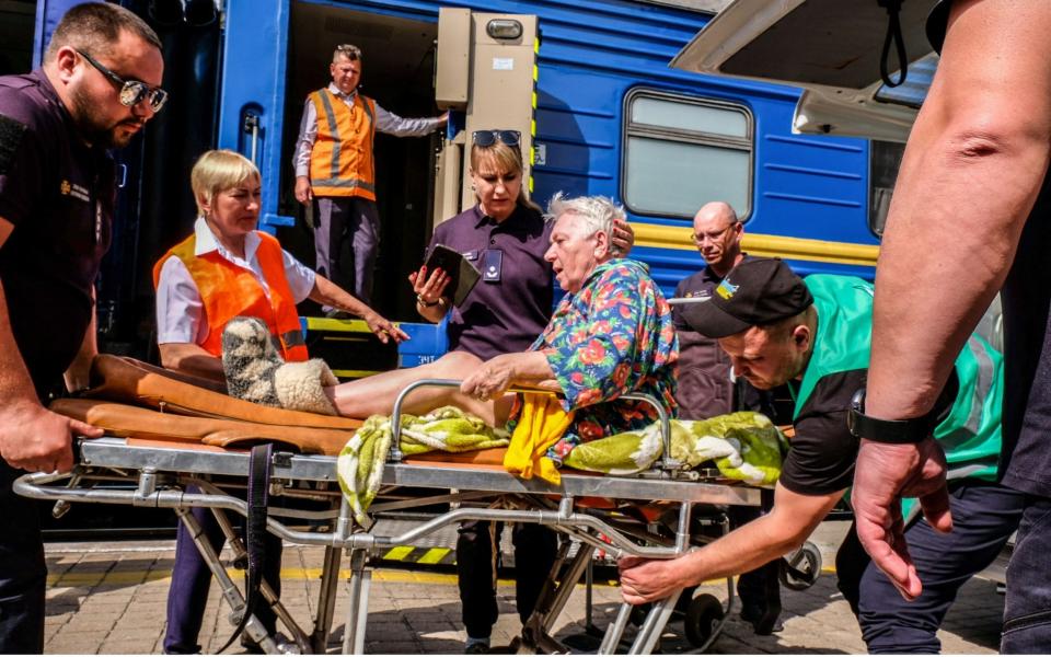 An elderly woman on a stretcher is transferred by volunteers on a train to be evacuated to Dnipro, a city on the Dnieper River in central Ukraine on 31 May, 2022  - Rick Mave/SOPA Images/Shutterstock