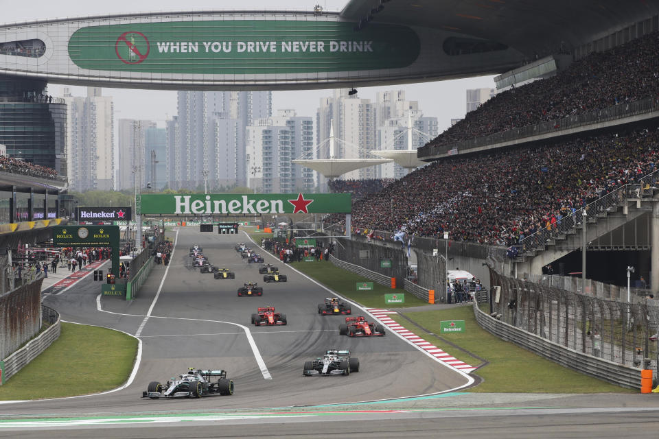 FILE - In this Sunday, April 14, 2019, file photo, drivers prepare for the start of the Chinese Formula One Grand Prix at the Shanghai International Circuit in Shanghai, China. Formula One's governing body on Wednesday, Feb. 12, 2020, says Shanghai Grand Prix scheduled for April postponed due to virus. (AP Photo/Ng Han Guan, File)