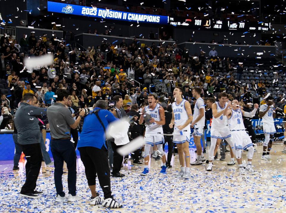 The Nova Southeastern University Sharks celebrate their victory over the West Liberty Hilltoppers during the championship game of the 2023 NCAA Division II Men’s basketball tournament at Ford Center in Downtown Evansville, Ind., Saturday afternoon, March 25, 2023.