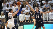 BYU guard Alex Barcello (13) shoots as Utah State forward Justin Bean (34) defends in the first half during an NCAA college basketball game Wednesday, Dec. 8, 2021, in Provo, Utah. (AP Photo/Rick Bowmer)