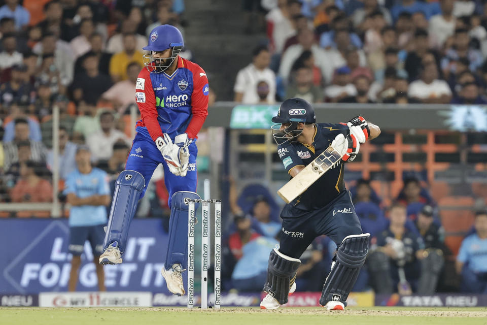 Delhi Capitals' captain Rishabh Pant, left, jumps up as Gujarat Titans' Mohit Sharma bats during the Indian Premier League cricket match between Delhi Capitals and Gujarat Titans in Ahmedabad, India, Wednesday, April 17, 2024. (AP Photo/Pravin Indrekar)