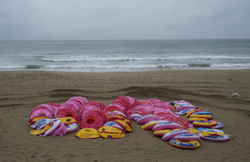 Deflated tubes are seen on a beach as the tropical storm named Khanun approaches to the Korean Peninsular, in Busan, South Korea, Wednesday, Aug. 9, 2023. Dozens of flights and ferry services were grounded in South Korea on Wednesday ahead of the tropical storm that has dumped heavy rain on Japan's southwestern islands for more than a week. (AP Photo/Ahn Young-joon)