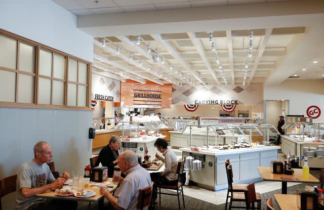 <p>Jonathan Wiggs/The Boston Globe via Getty</p> People eat at the buffet-style restaurant Golden Corral in Manchester, NH on May 12, 2022.