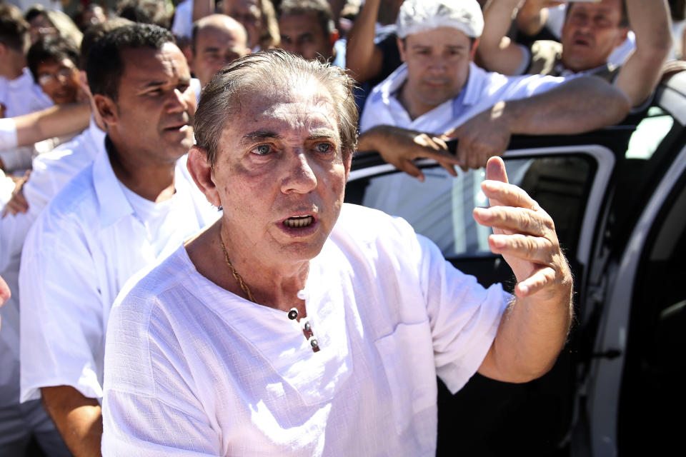 In this handout photo released by Agencia Brasil, spiritual healer Joao Teixeira de Faria, better known as John of God, arrives to the Dom Inacio Loyola House in Abadiania, Brazil, Wednesday, Dec. 12, 2018. Authorities say that more than 200 people have come forward to accuse the spiritual healer of sexual abuse in the central Brazilian state of Goias. The accusations against Faria began last week after several alleged victims spoke of abuse on a popular Brazilian television show. (Marcelo Camargo/Agencia Brasil via AP)