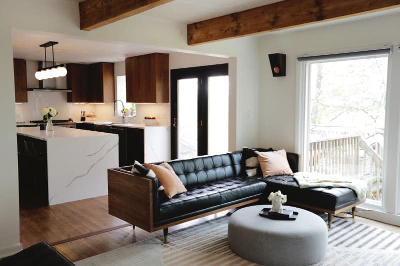 Black leather sofa in light filled living room.