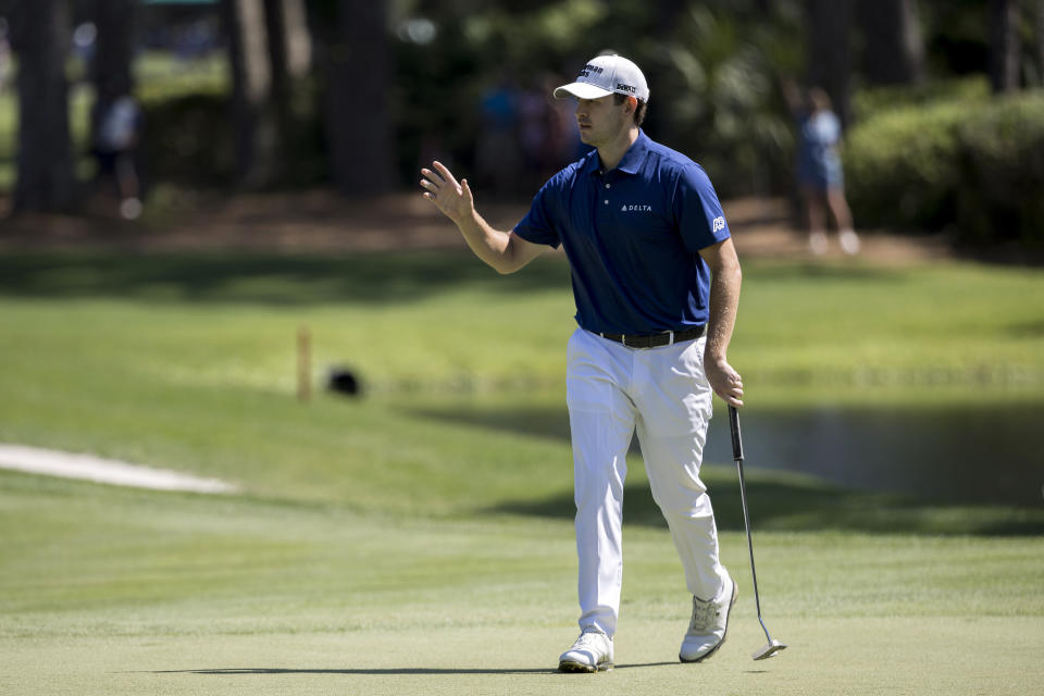 Patrick Cantlay waves to the gallery after making a birdie putt on the eighth hole during the third round of the RBC Heritage golf tournament, Saturday, April 15, 2023, in Hilton Head Island, S.C. (AP Photo/Stephen B. Morton)