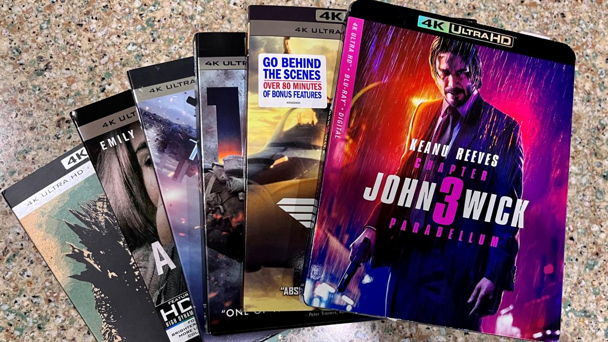  4K Blu-ray action movies splayed out on a kitchen counter. 