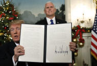 With Vice Pence Mike Pence looking on, U.S. President Donald Trump displays an executive order after he announced the U.S. would Jerusalem as the capital of Israel, in the Diplomatic Reception Room of the White House in Washington, U.S., December 6, 2017. REUTERS/Kevin Lamarque