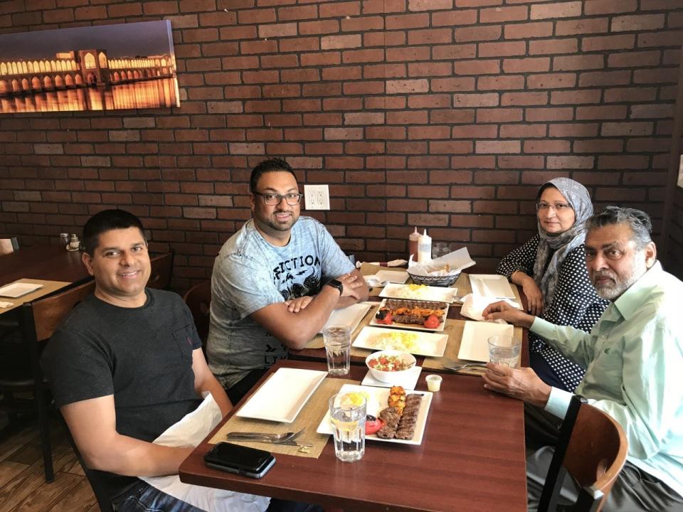 Sameer Sarmast sits with his cousin Sameer Ahmed and his parents, Amina and Syed Sarmast, at their favorite restaurant Kabob on the Cliff in New Jersey.