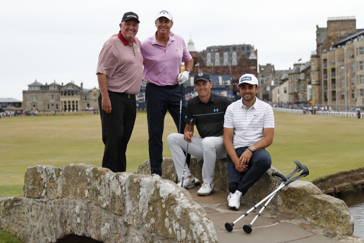 Golfers Mark Calcavecchia, Ian Baker-Finch, Jordan Spieth and Juan Postigo Arce, from left, pose for a photo on the Swilken Bridge during a 'Champions round' as preparations continue for the British Open golf championship on the Old Course at St. Andrews, Scotland, Monday July 11, 2022. The Open Championship returns to the home of golf on July 14-17, 2022, to celebrate the 150th edition of the sport's oldest championship, which dates to 1860 and was first played at St. Andrews in 1873. (AP Photo/Peter Morrison)
